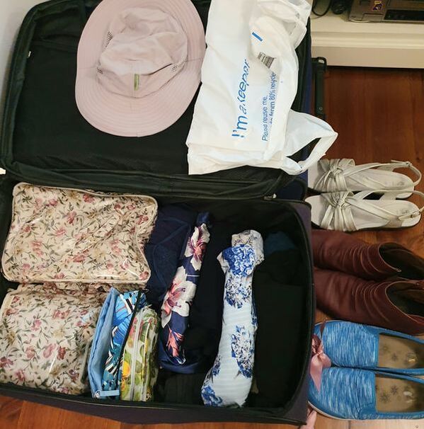 Suitcase with clothes for holiday in Italy and Cyprus