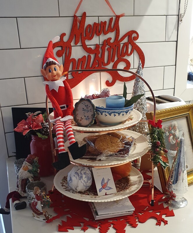Elf sitting on plate stand full of Christmas cuteness