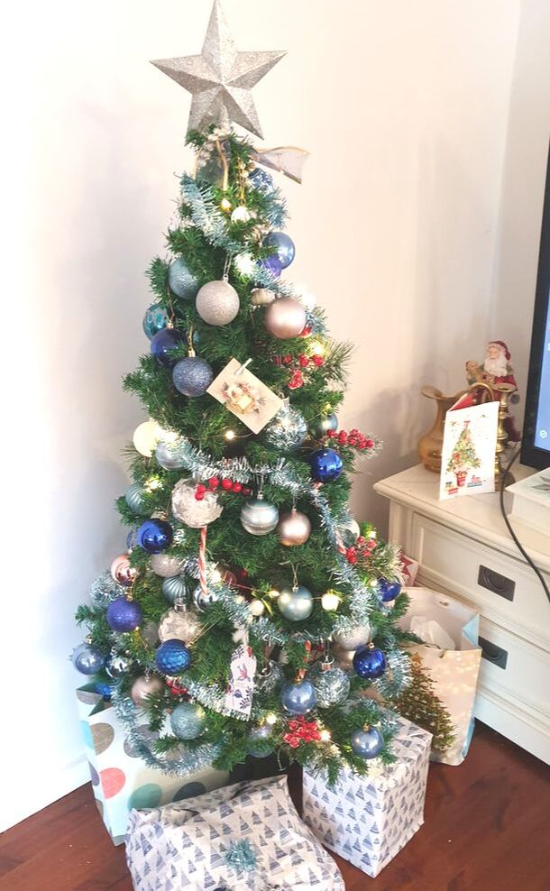 Blue and White Tree with tinsel and presents. 